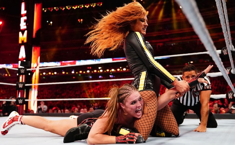 Becky has Ronda pinned underneath her.