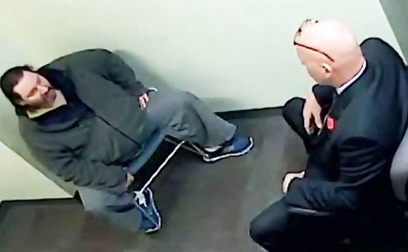 A still of Adam during interrogation.