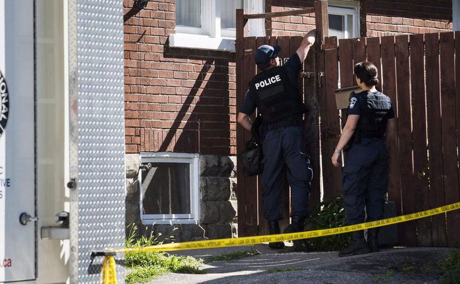 A photo of police officers searching Adam’s house.