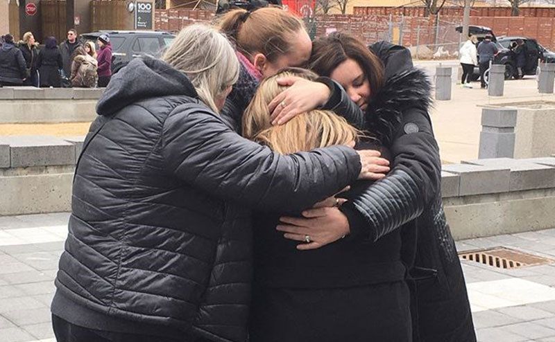 A picture of Kandis’ family embracing one another outside court.