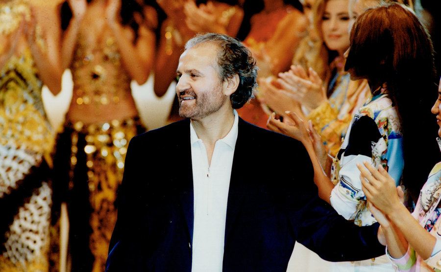 A photo of Gianni Versace on the runway.