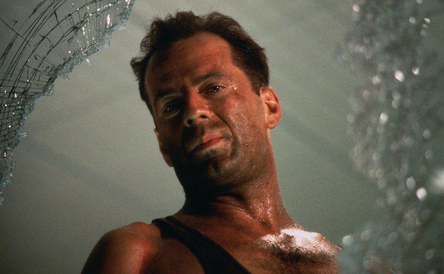 Bruce Willis stands behind broken glass in a still from the film.