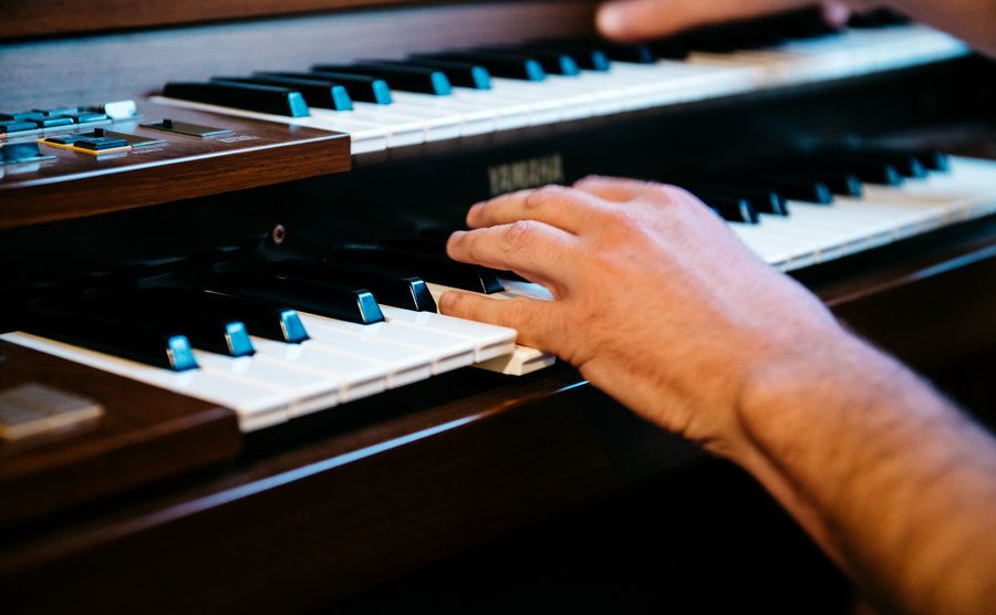 An image of a man playing the organ.