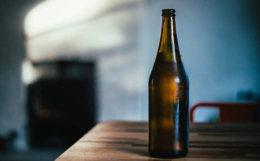 An image of a bottle of beer on a counter.