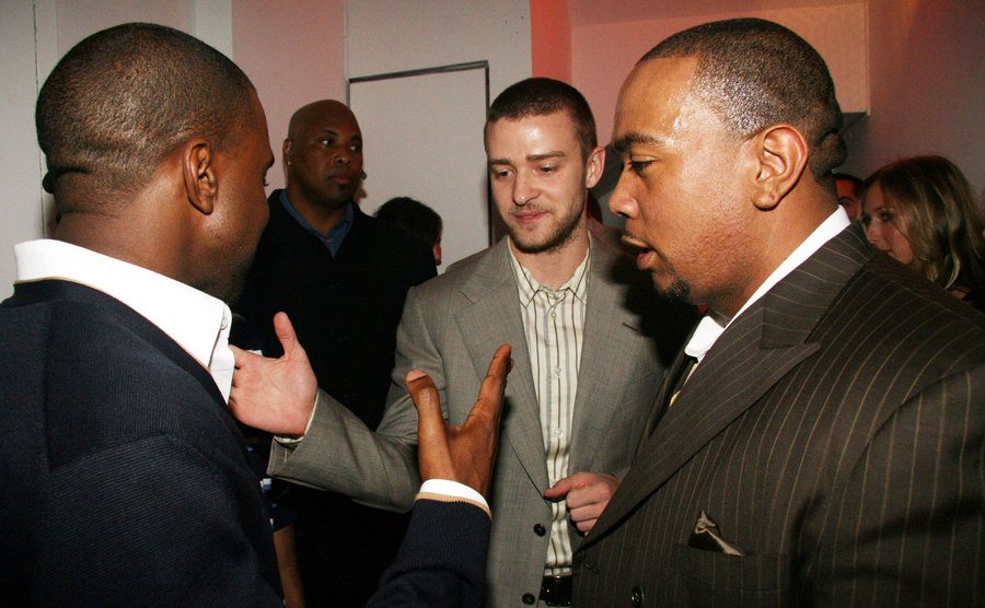 Kanye West and Justin Timberlake shake hands backstage.