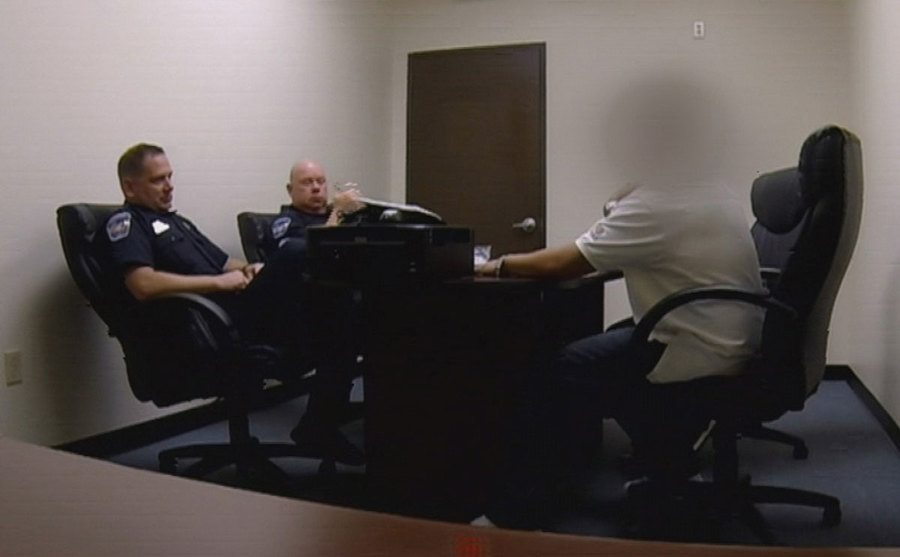 A still of Mundo during a conversation with police officers at the station.