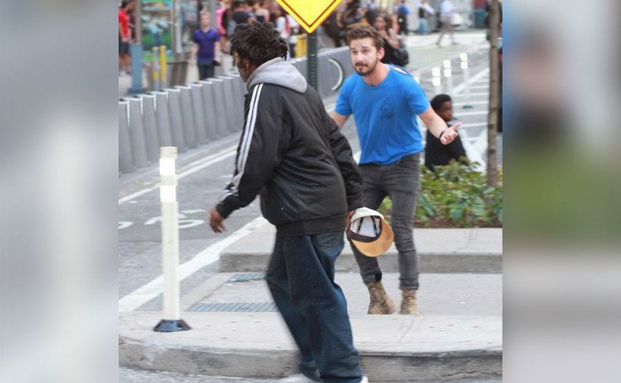 Shia LaBeouf chases after a homeless man. 
