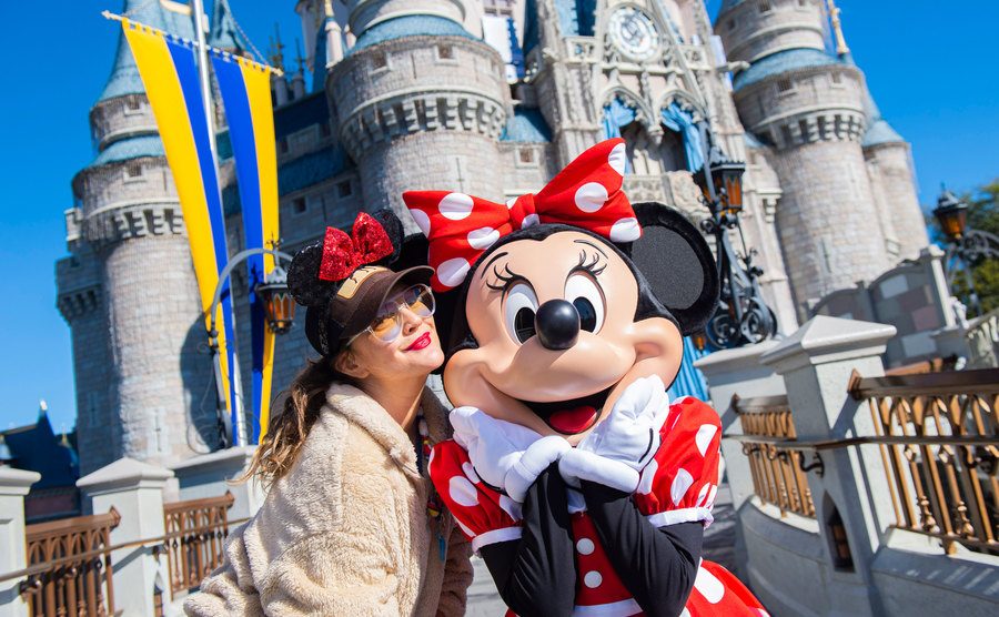 Drew Barrymore poses with Minnie Mouse at Walt Disney World Resort.