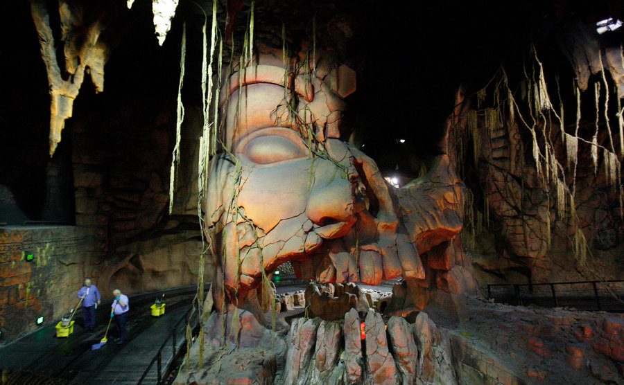 Janitors mop the Indiana Jones Adventure ride floor before the park opens.