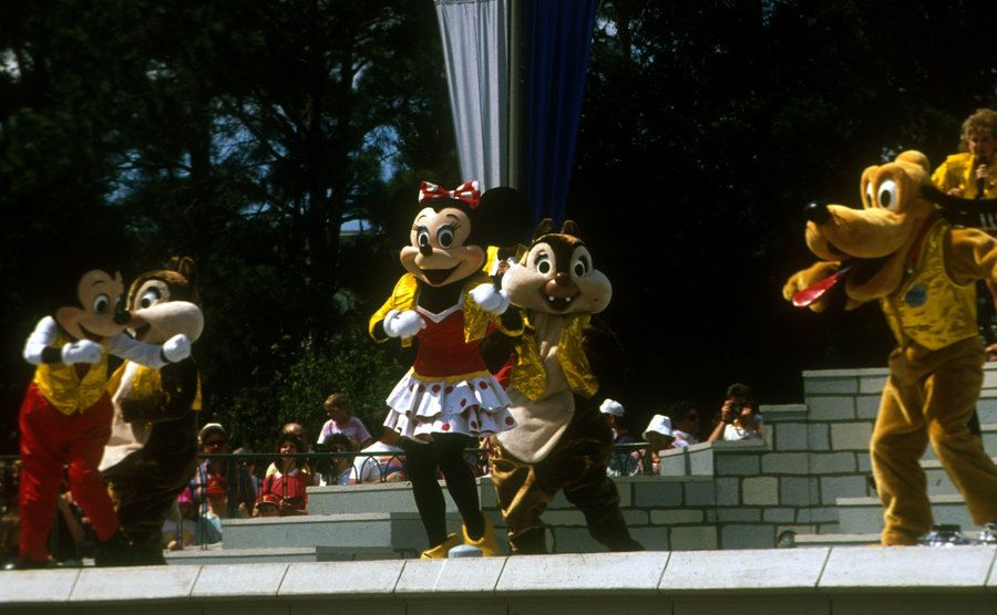 A photo of the famous Disney characters during a parade.