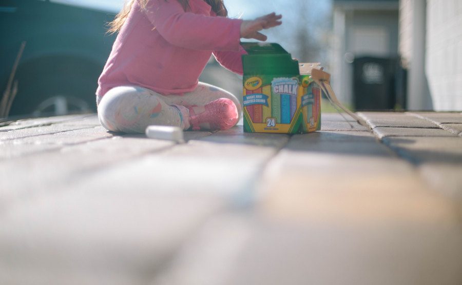 A small girl plays with her toys.