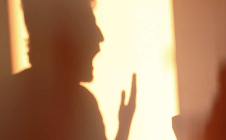 A shadow of an aggressive father shouting.