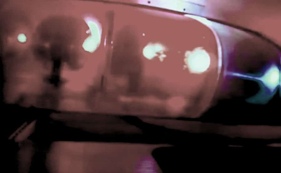 An image of red flashing lights from a police patrol.