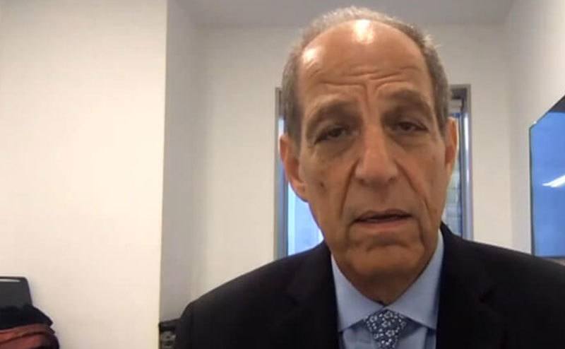 A still of Paul Mones speaking during an interview.