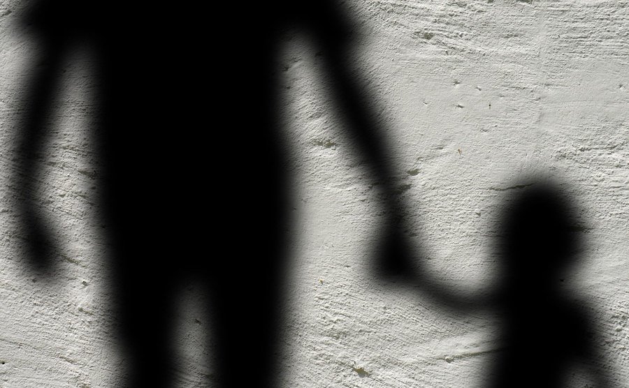 A shadow of a father holding his daughter’s hand.