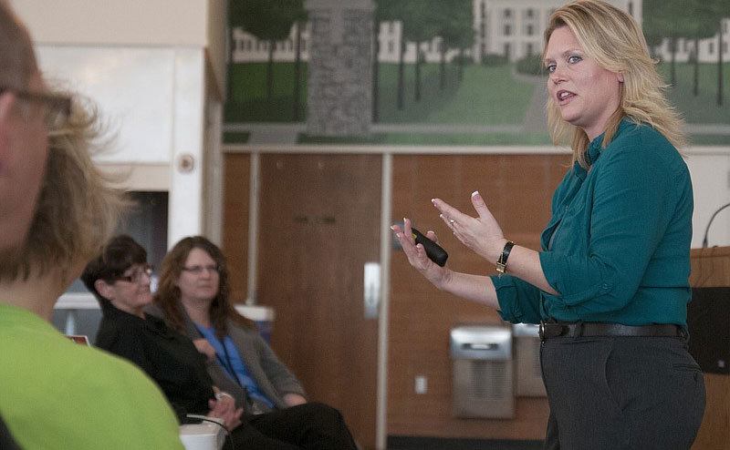 A photo of Stacey giving a lecture after her time in prison.
