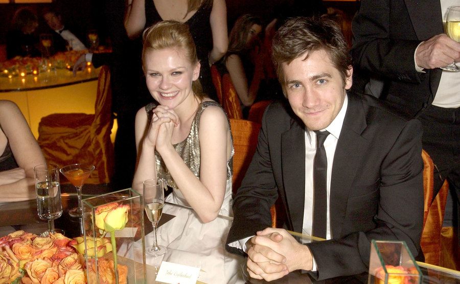 Kirsten Dunst and Jake Gyllenhaal sit together at an event.