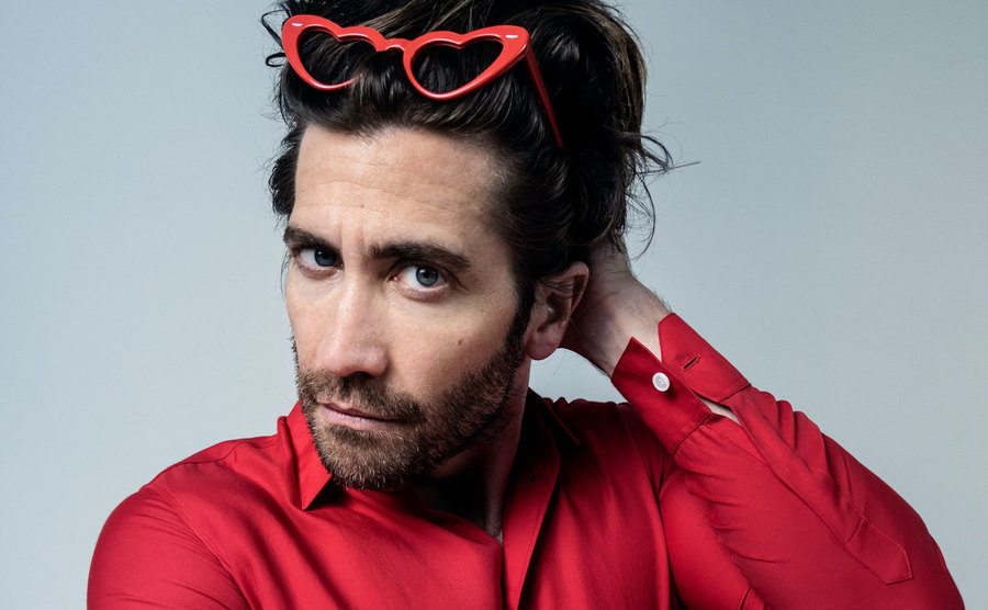 Gyllenhaal poses in red while wearing Taylor’s iconic heart sunglasses.