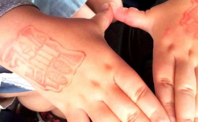 An image of a kid’s stamped hands.