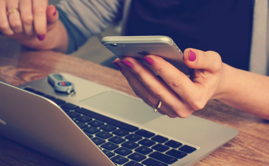 An image of a woman staring at a phone screen.