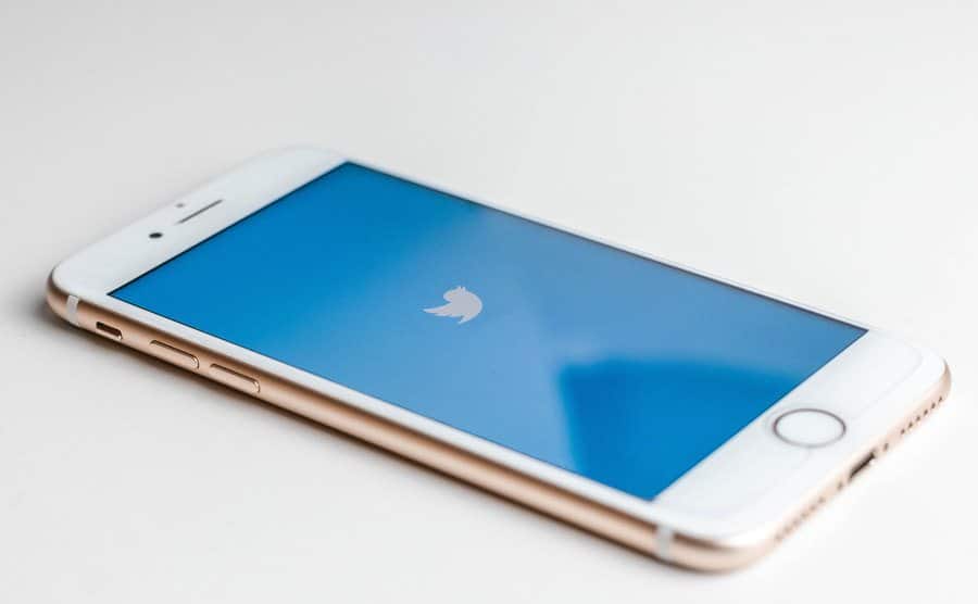 The logo of Twitter is displayed on a screen.