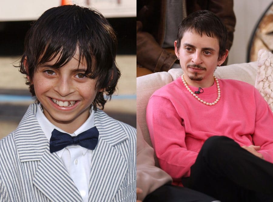 Moises Arias at the Nacho Libre film premiere in 2006. / Moises Arias at day 2 of the Sundance Film Festival in 2020 wearing a pink sweater, a pearl necklace, and sporting a mustache and small beard. 
