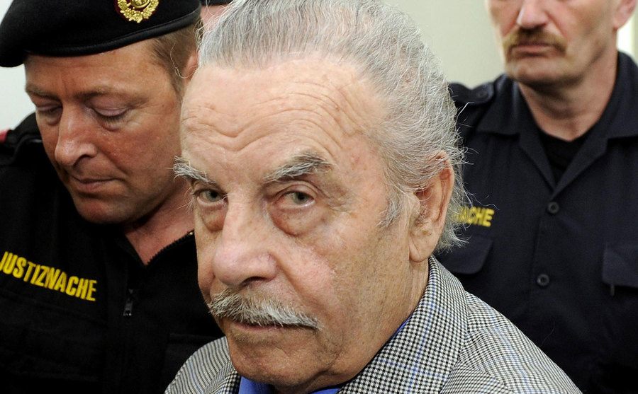Police escort Josef Fritzl to court. 