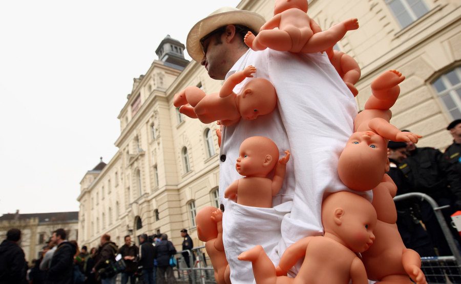 An Austrian artist manifests in front of the court building during the trial.