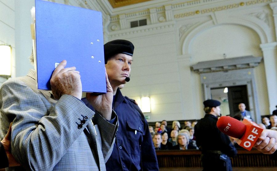 Josef Fritzl covers his face as he arrives at the beginning of his trial.