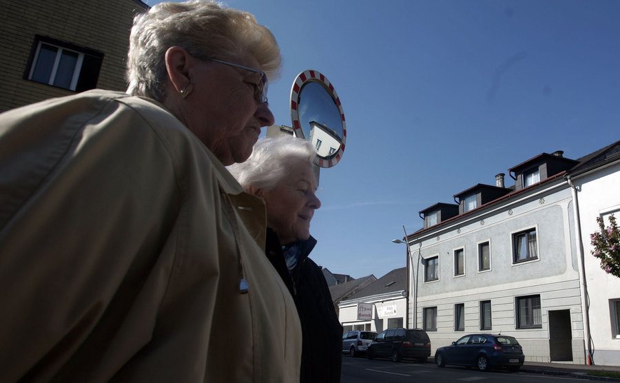 Shocked inhabitants of Amstetten are seen in front of the house.