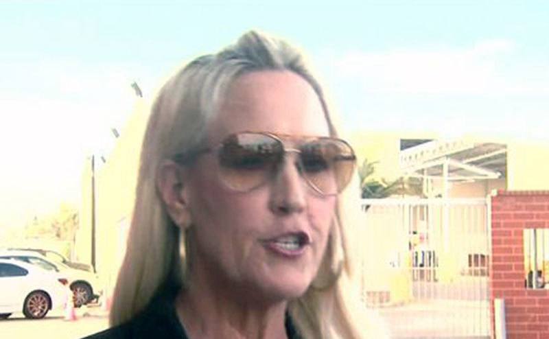 A video still of Erin talking to the media.
