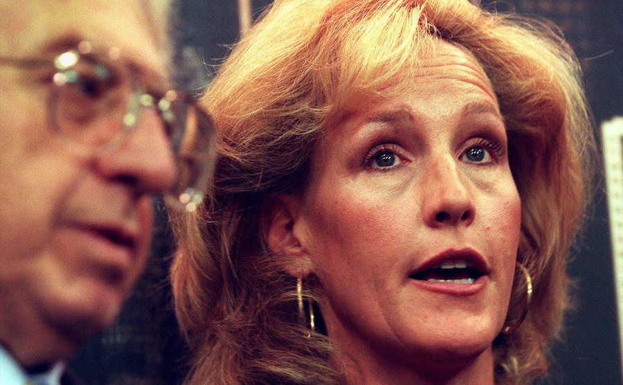 A picture of Erin Brockovich speaking to reporters.