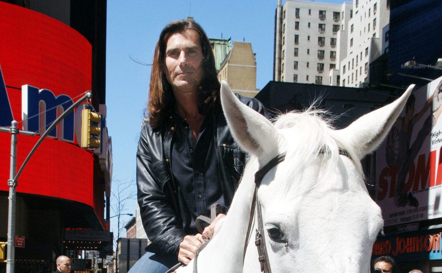 Fabio rides a horse into Times Square.