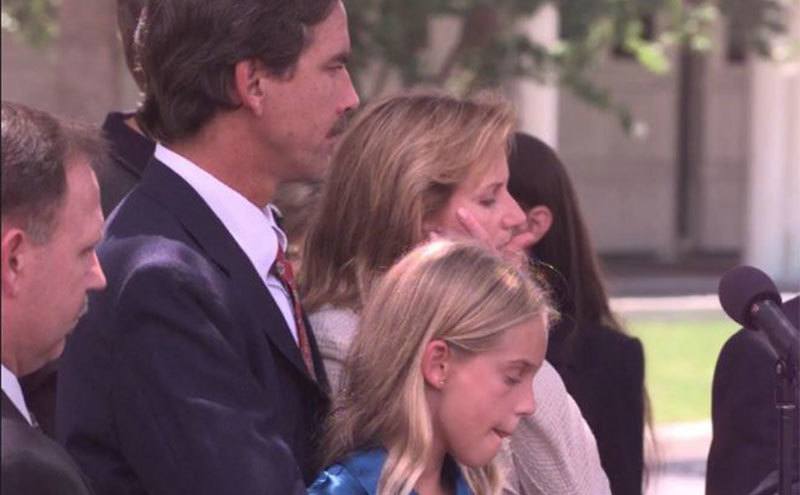 Steve Clifton stands behind his wife and daughter during a press conference.