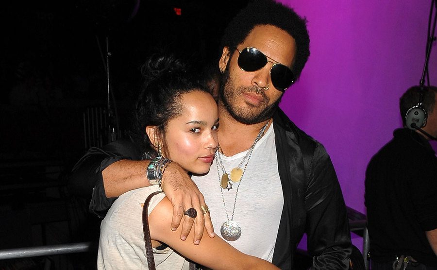 Zoe Kravitz and Lenny Kravitz hug backstage. 
