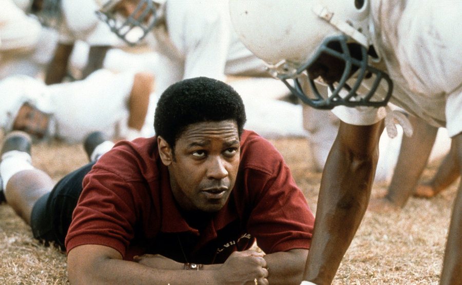 Coach Boon played by Demzel runs his players through training. 
