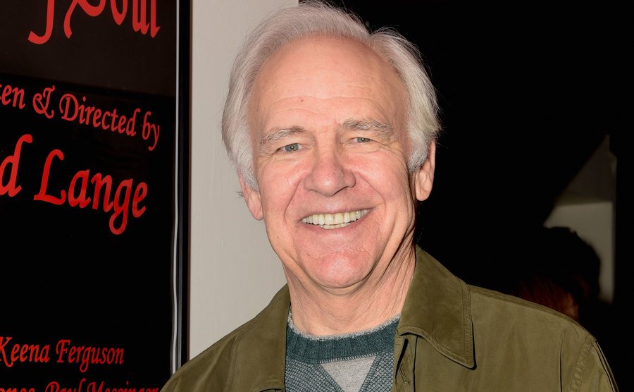 A portrait of Robert Pine during an event.