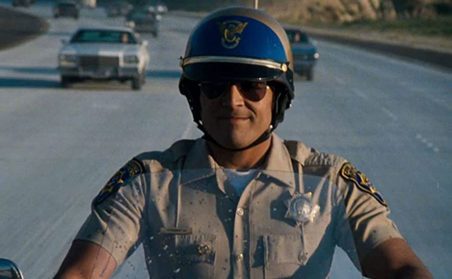 A still of Estrada riding a motorcycle.