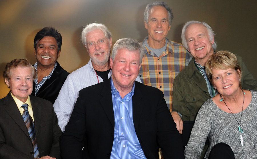 Former cast members of the show pose together for the press.