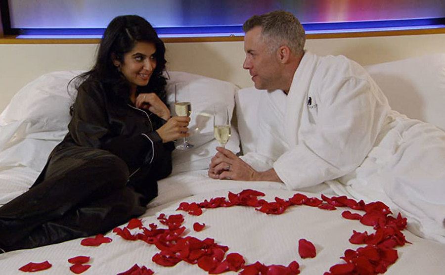Davina Kullar and Sean Varricchio share a romantic moment in bed.