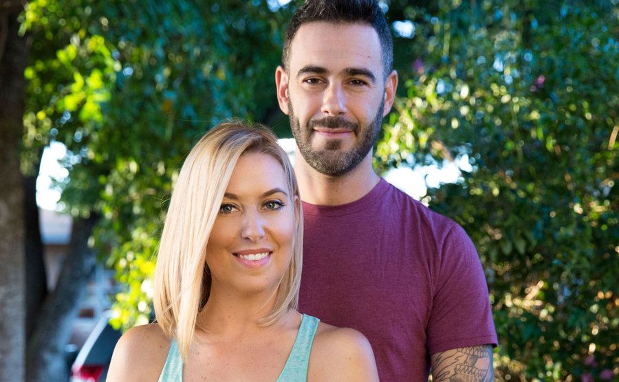 Heather Seidel and Derek Schwartz pose in their backyard.