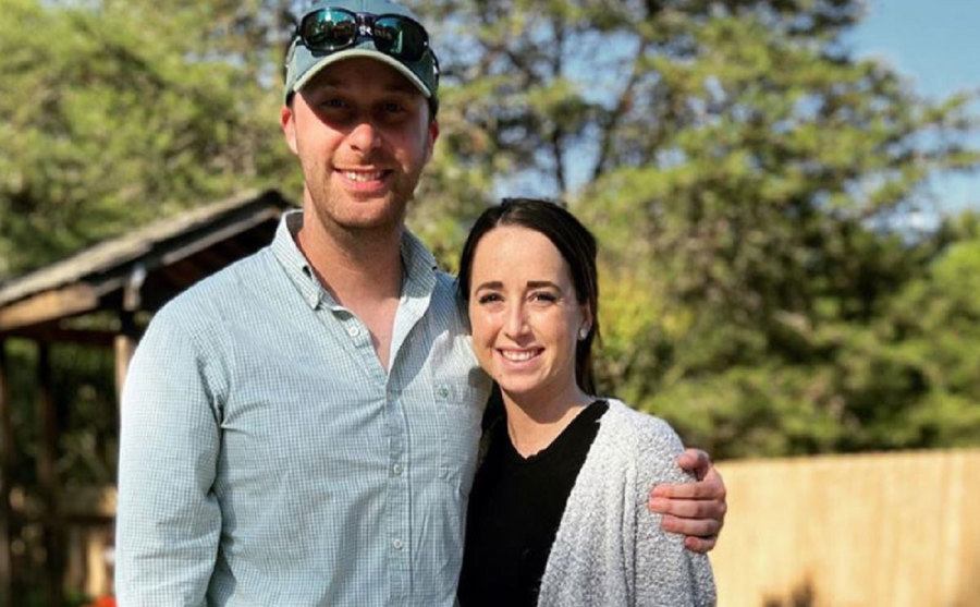 Derek Sherman and Katie Conrad pose in their backyard.