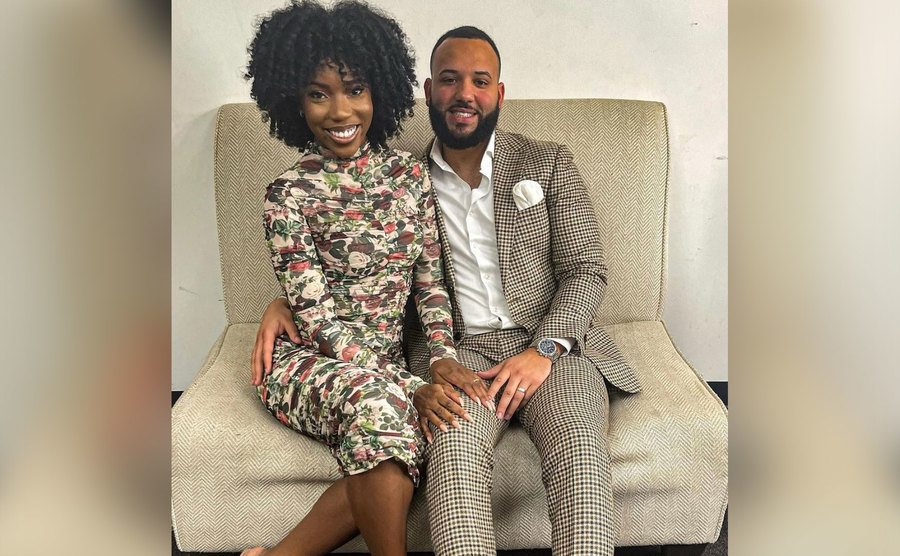Briana and Vincent pose together on a couch.