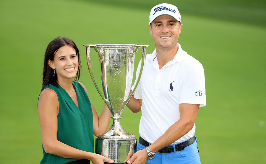 Justin Thomas celebrates with girlfriend Jillian Wisniewski after winning