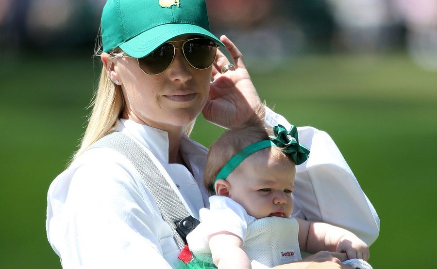 Dowd Simpson, walks with the couple's children during the Par 3 Contest.