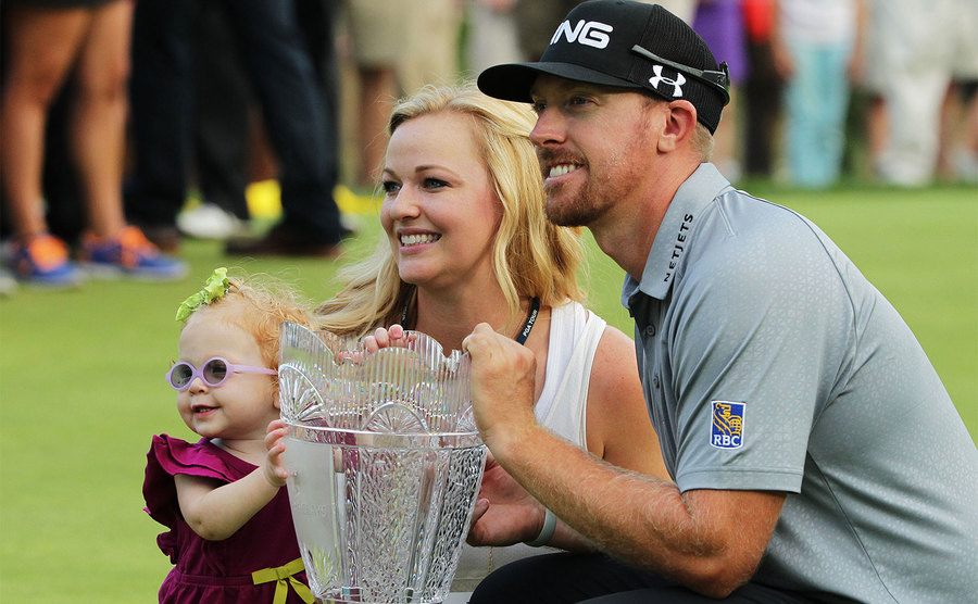 Hunter Mahan celebrates with his wife Kandi, daughter Zoe and the tournament trophy.