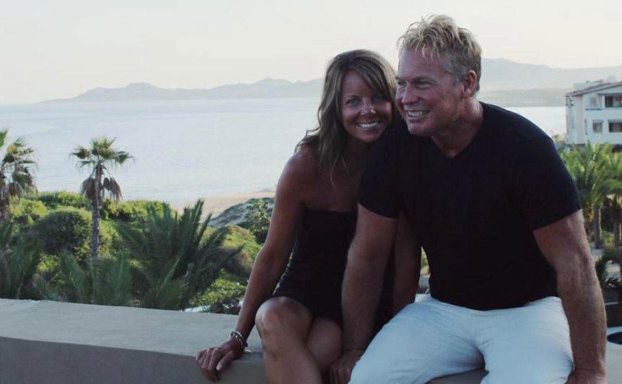 A dated photo of Suzanne smiling next to Barry.