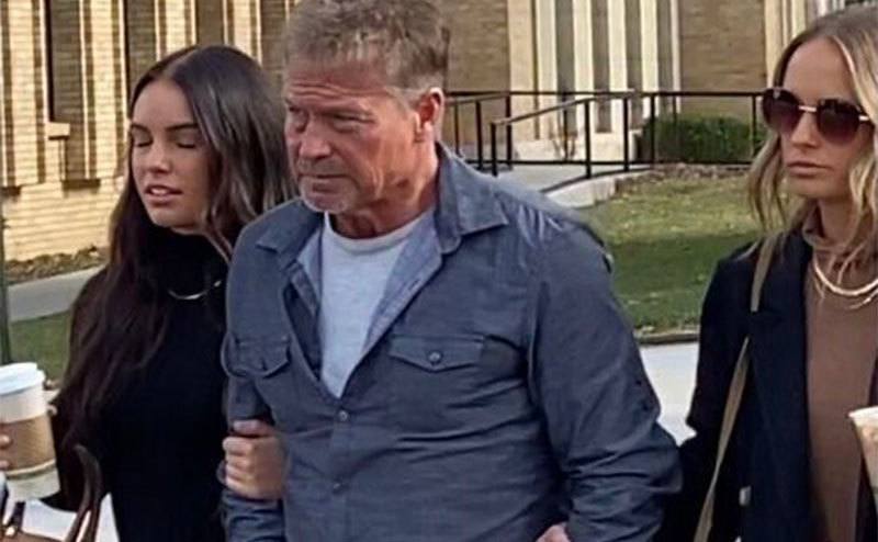 A picture of Barry with his daughters outside the courthouse.