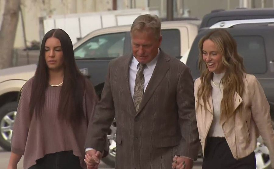 An image of Barry, Mallory, and Macy walking to court.