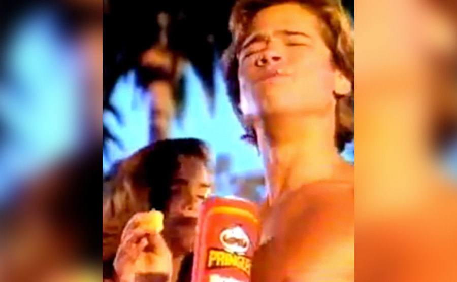 Brad Pitt is enjoying a container of Pringles.